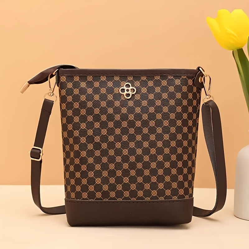 a vintage geometric patterned crossbody bag featuring a lightweight adjustable shoulder strap a zip closure polyester lining   capacity and pockets for a phone and   a versatile bag suitable for   occasions details 0